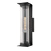 22 Inch Black Crate & Barrel Stirling Outdoor Wall Sconce Light in textured black iron and steel with a ribbed glass tube shade, shown in the main product view