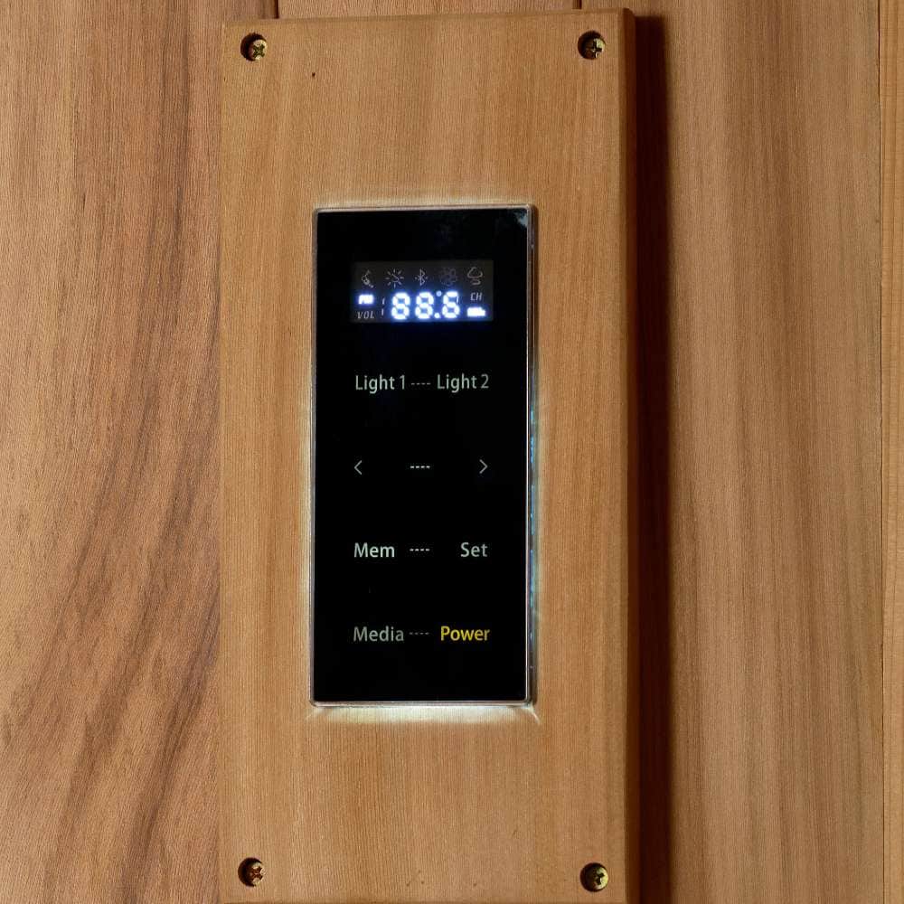 A black digital control panel with a lit display sits in a cedar frame on the wall of Golden Designs Osla 6 Person Traditional Sauna