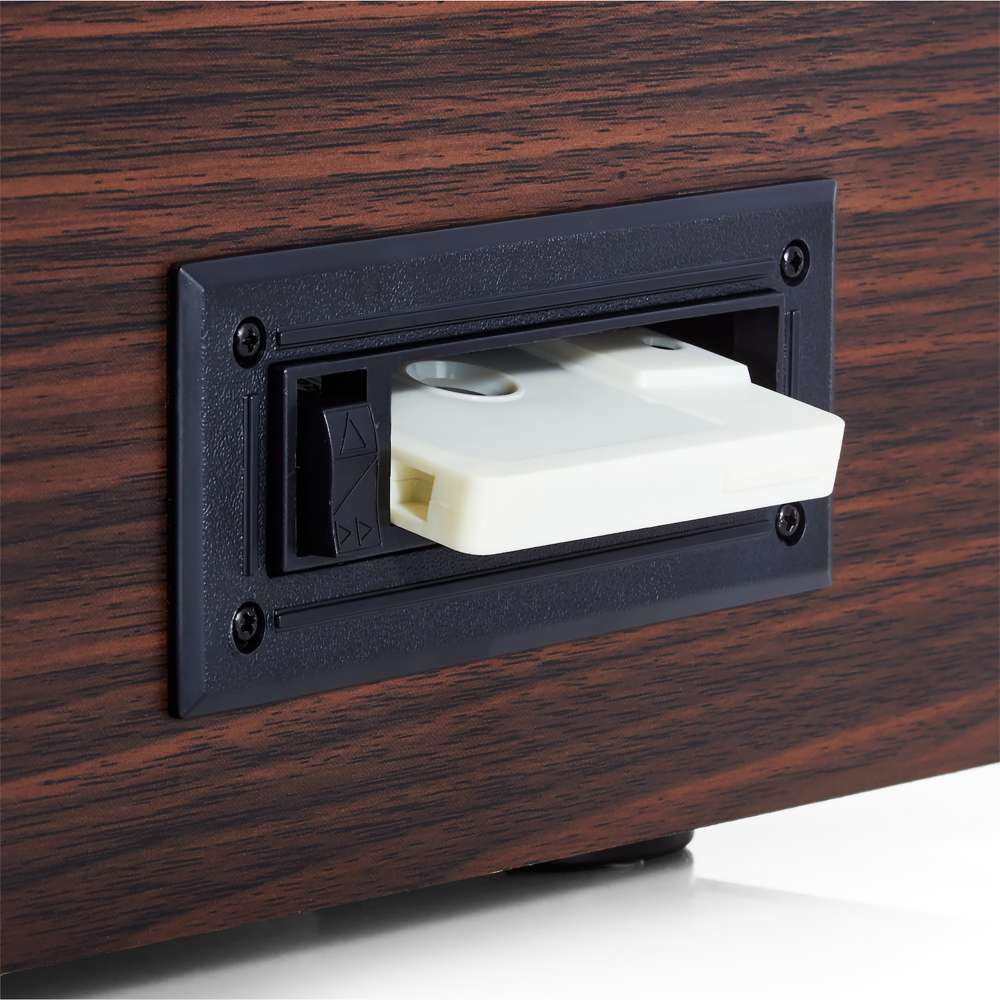 A cassette is inserted into the side of the Victrola Empire Bluetooth Record Player