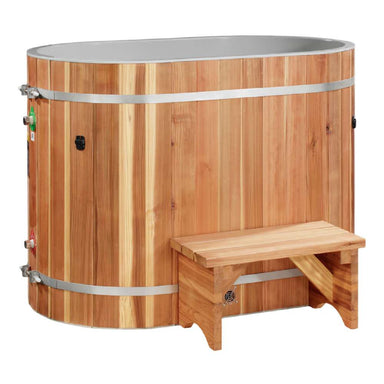 A cedar step sits in front of Golden Designs Dynamic Cold Therapy Oval Barrel Pacific Cedar Cold Plunge, an oval tub wrapped in vertical cedar staves and steel bands