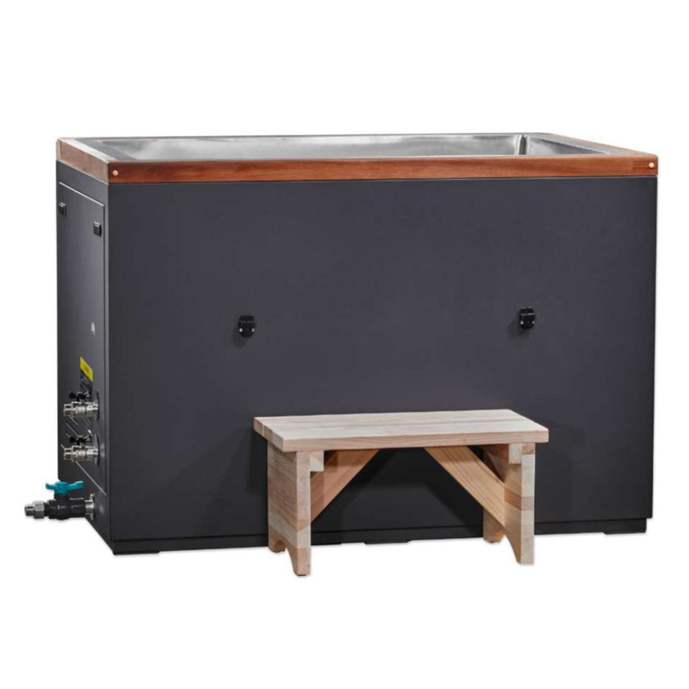A light wood step stands before Golden Designs Dynamic Cold Therapy Cuboid 304 Nano-Coated Stainless Steel Cold Plunge Tub XL, a long dark cabinet with cedar trim around the top