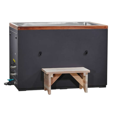 A light wood step stands before Golden Designs Dynamic Cold Therapy Cuboid 304 Nano-Coated Stainless Steel Cold Plunge Tub XL, a long dark cabinet with cedar trim around the top