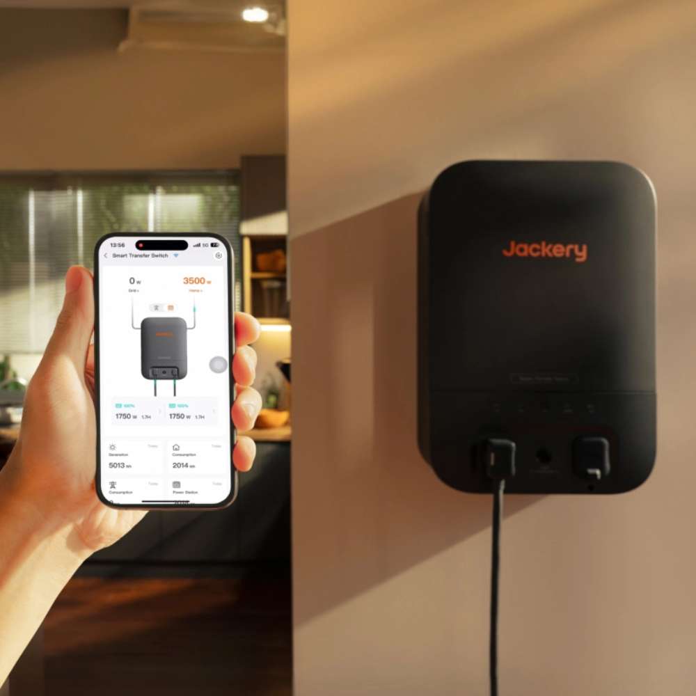 A smartphone app monitoring Jackery Smart Transfer Switch mounted on a wall for remote backup power management