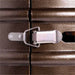A stainless latch holds the bronze base door closed on Outdoor Order Halo Traditional Heater