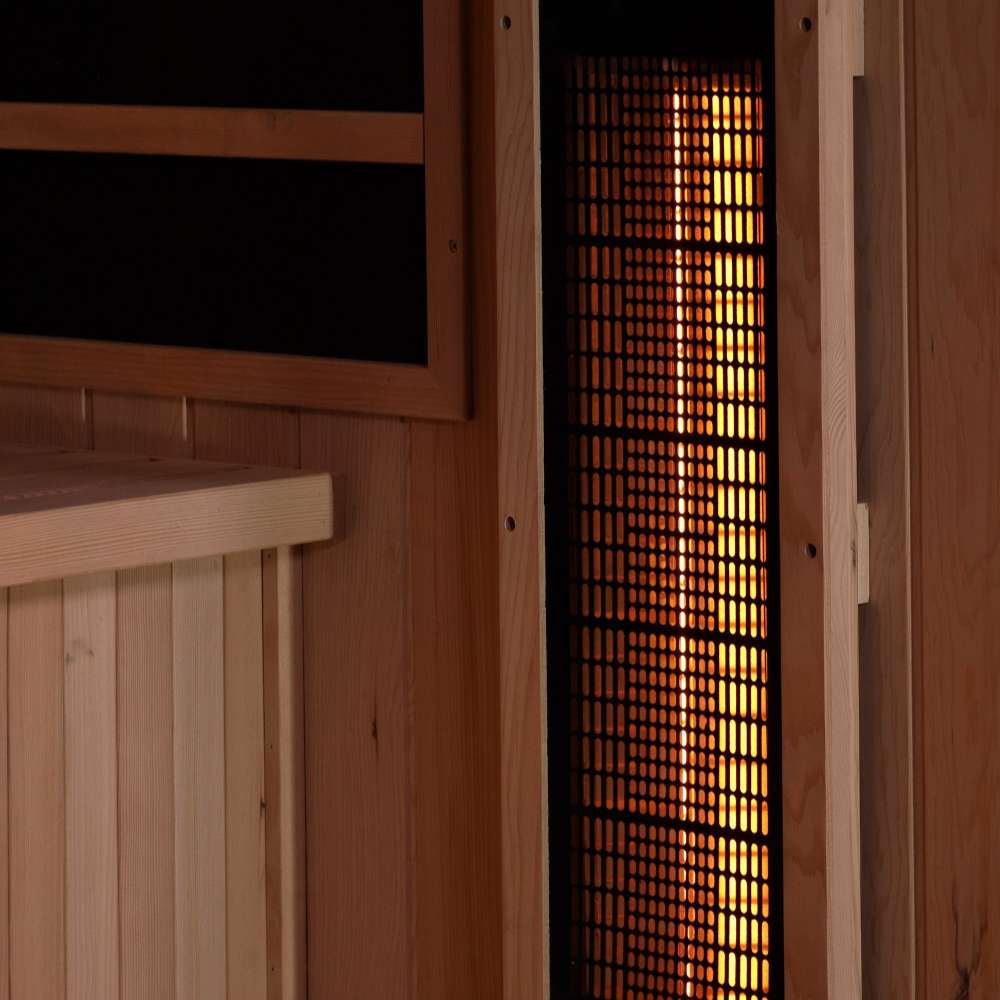A vertical near infrared heater glows orange behind a black grille in the side wall of Golden Designs Reserve Edition 3 Person Full Spectrum Sauna with Himalayan Salt Bar