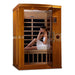 A woman in a white towel relaxes on the bench inside Golden Designs Dynamic Venice Elite 2 Person Ultra Low EMF Far Infrared Sauna