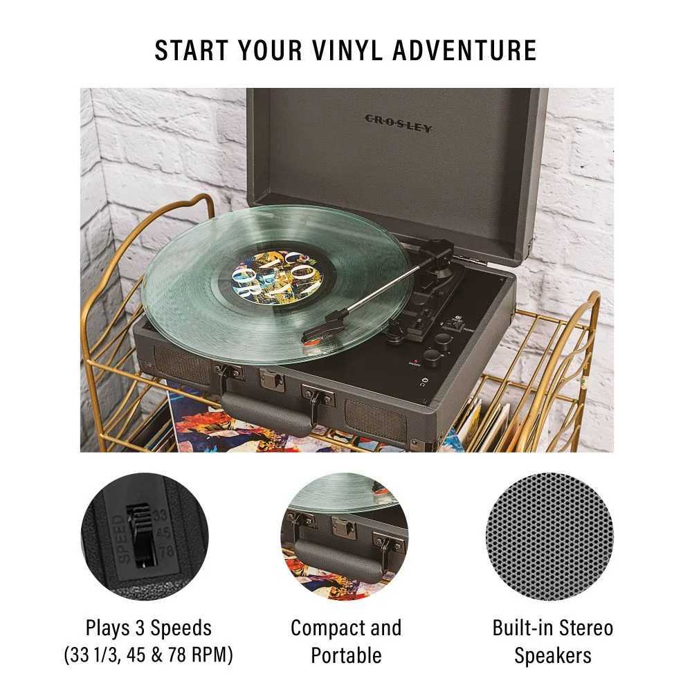 A Crosley Cruiser Plus Portable Turntable with Bluetooth InOut - Slate is shown playing a green vinyl record