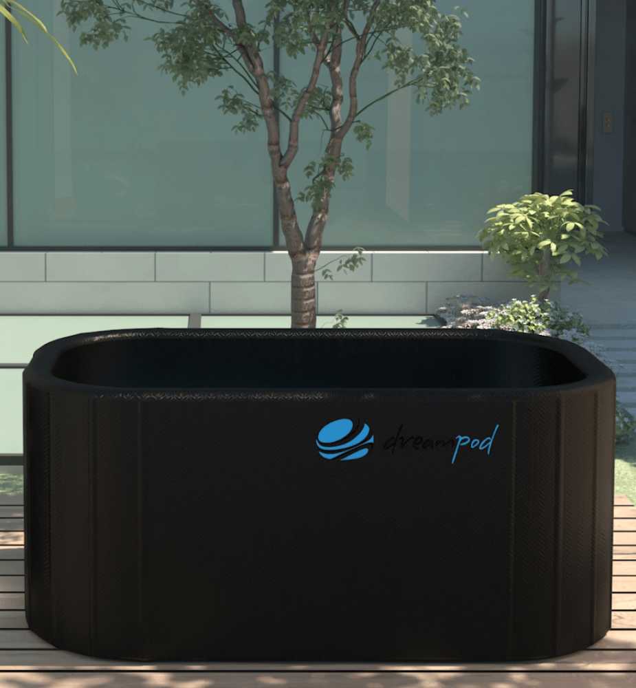 A Dreampod Cold Plunge Barrel FLEX with Chiller in a minimalist outdoor setting with a small tree in the background