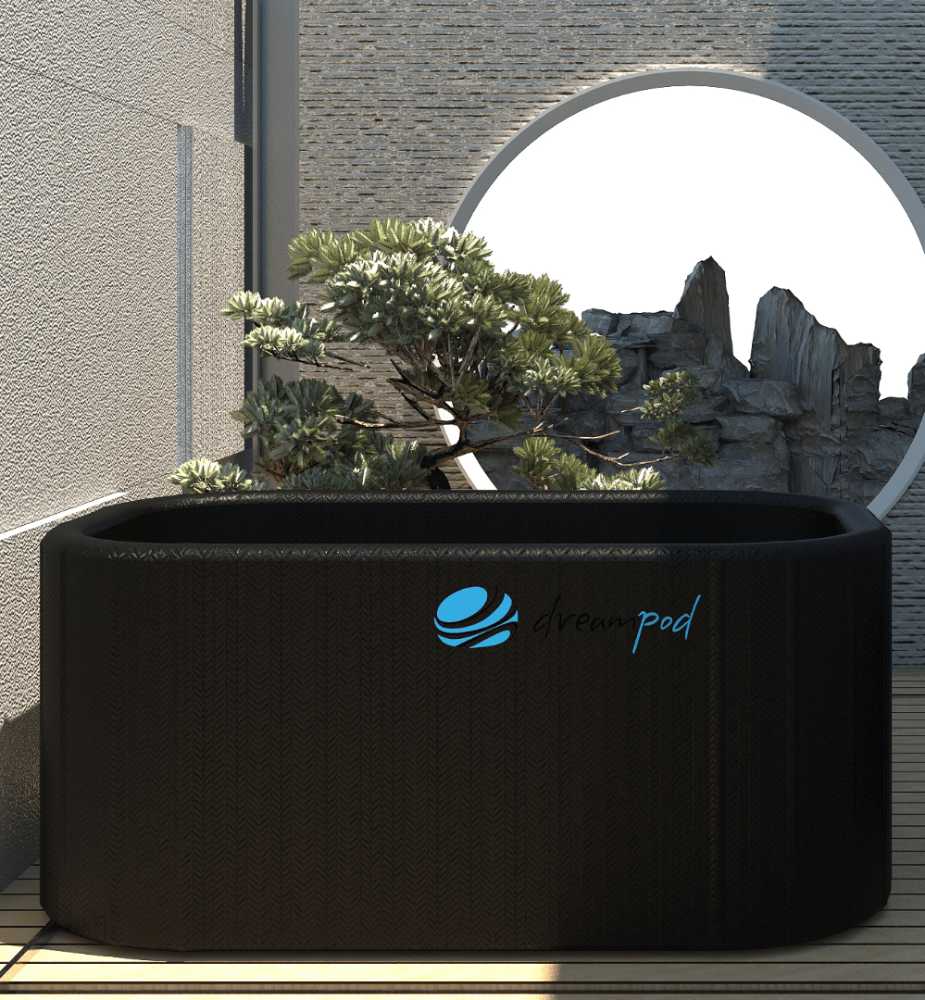 A Dreampod Cold Plunge Barrel FLEX with Chiller in an outdoor area with a modern, circular window and decorative stone wall