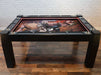 A Game Theory Tables Origins Lit table showcasing a Dungeons & Dragons battle scene artwork, with sleek black frame and polished cup holders