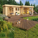 A cozy and modern wooden cabin with a spacious deck and glass sliding doors, nestled in a lush forest, showcases the GardenHouse24 USA ALU Concept 70K Garden Room