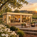 Front-left angled view of the ALU Concept Lounge 44B at golden hour in North Carolina’s Yadkin Valley, surrounded by vineyards, mature oaks and flowering dogwoods, with three adults socializing around an illuminated indoor bar.