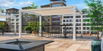 A black Structureworks Solis Trex Pergola with a decorative privacy wall provides shade over a stylish outdoor sofa set