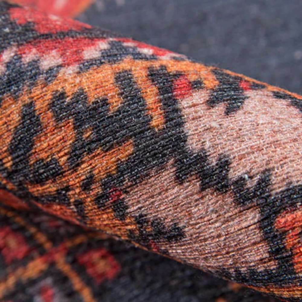 A close-up of Momeni Afshar Indoor Rug - AFS16 Red reveals its soft woven texture and fine detailing in vibrant contrasting hues