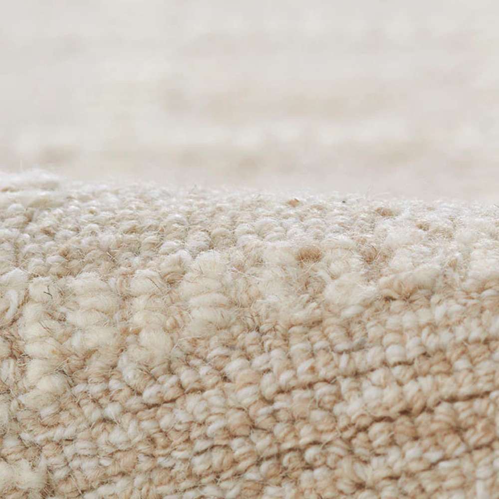 A close-up of Momeni Archer Indoor Rug - ARC-3 Beige highlights its looped texture and plush wool blend