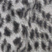 A close-up of the surface design of Couristan Dolce Indoor/Outdoor Rug - Lynx/Ivory-Charcoal reveals its abstract leopard-like pattern