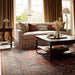 A close-up shows Momeni Afshar Indoor Rug - AFS37 Red beneath a sofa and coffee table