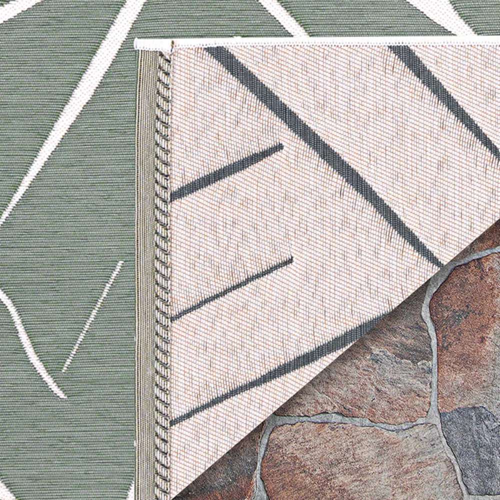 A close-up shows the corner of Couristan Dolce Indoor/Outdoor Rug - Parquet/Fern flipped over