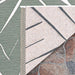 A close-up shows the corner of Couristan Dolce Indoor/Outdoor Rug - Parquet/Fern flipped over