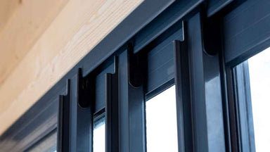 A close-up shows the sturdy aluminum track system for the sliding glass doors of the GardenHouse24 USA ALU Concept 44Q Garden Room
