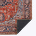 A corner fold of Momeni Afshar Indoor Rug - AFS37 Red highlights its durable backing and intricate antique-inspired patterns
