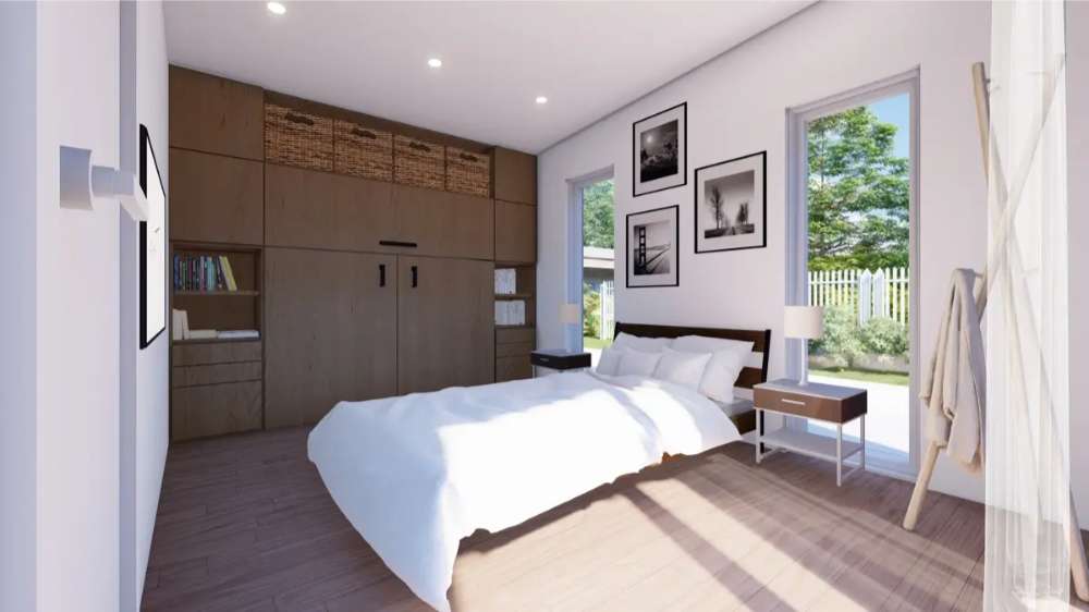 A cozy bedroom in Sawmill Structures The Muskoka Garden Suites has a large bed, natural light from tall windows, and built-in wood storage units