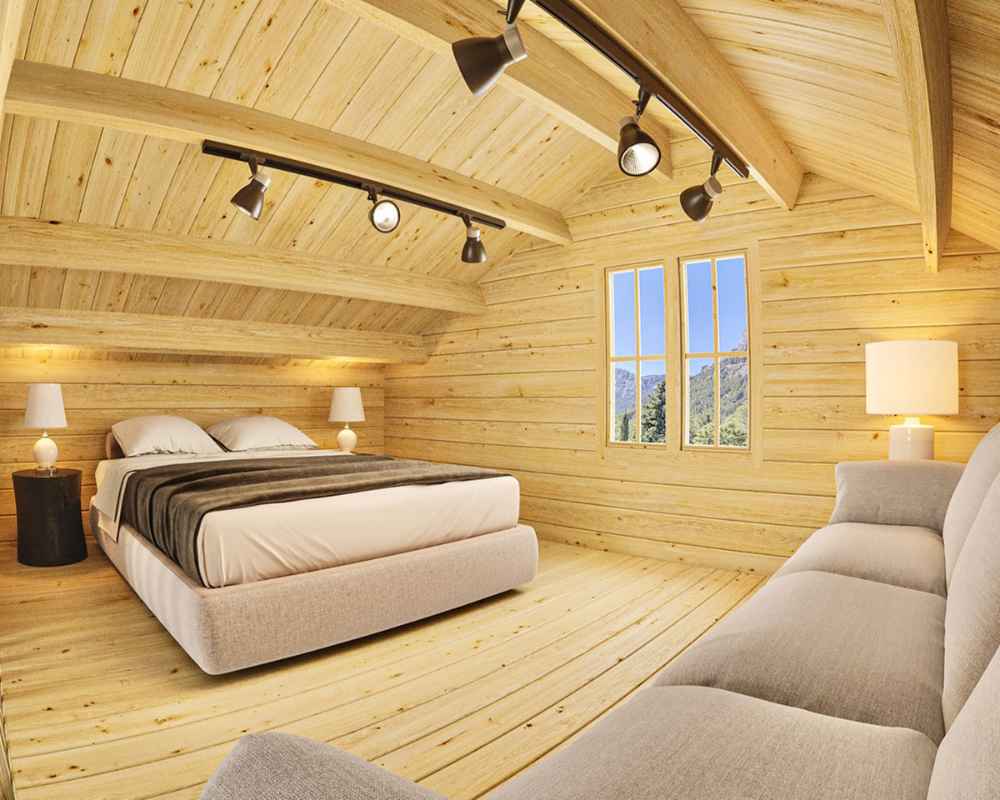 A cozy bedroom with a sloped wooden ceiling and modern lighting features a plush bed and couch inside Sawmill Structures The Northwood Grand SD 70mm Garden Room