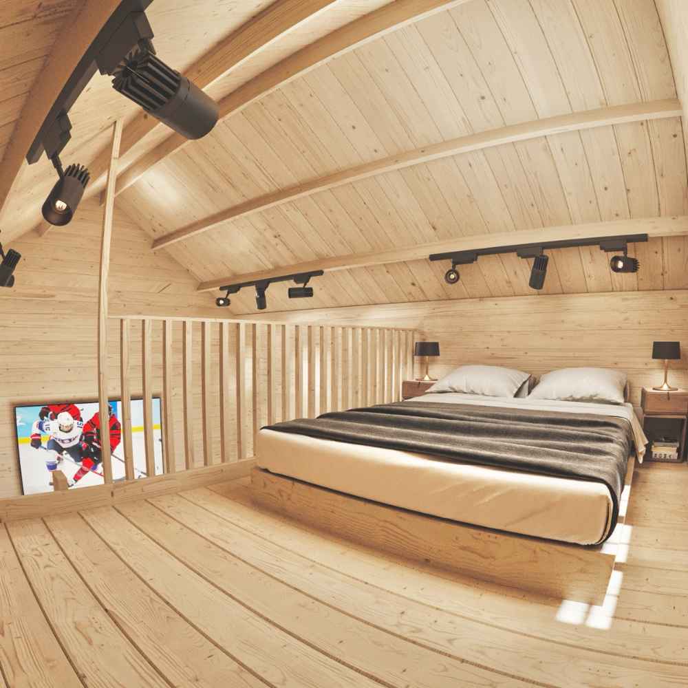 A cozy loft bedroom with a large bed and black ceiling spotlights is part of the Sawmill Structures Ontario Grand Loft 107 SD Garden Room