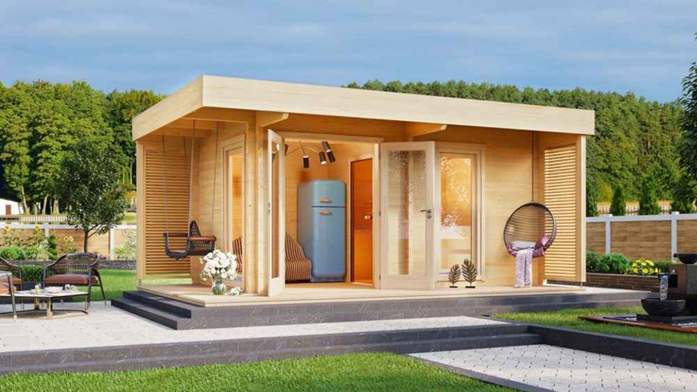 A cozy, modern wood-paneled GardenHouse24 USA Asta 70 Garden Room sits in a landscaped garden with an open door revealing a vintage blue fridge inside