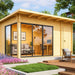 A cozy wooden GardenHouse24 USA Starla 44B ALU Garden Room with large glass sliding doors and a garden backdrop