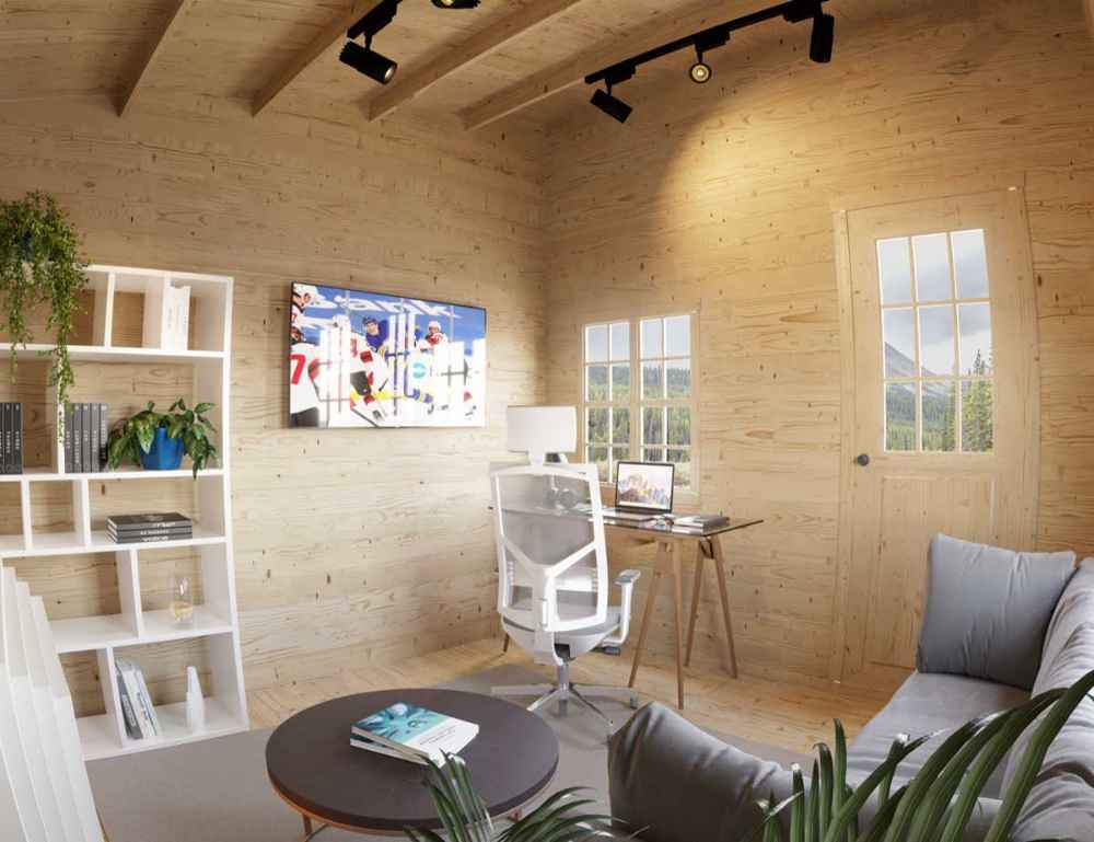 A cozy workspace with wood walls, a white desk and chair, bookshelves, and natural light is shown inside the Sawmill Structures Multi Cube Versa 100 Garden Room