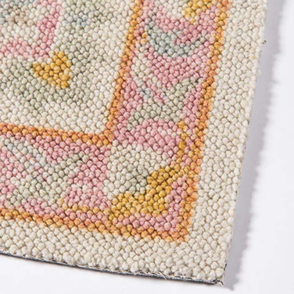 A finished edge of Momeni Anatolia Indoor Rug - ANA-8 Pink displays clean stitching and a soft pastel border