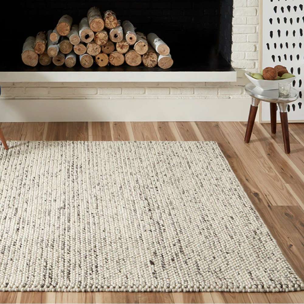 A fireplace area brightened by Momeni Andes Indoor Rug - AND-8 Ivory