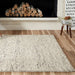 A fireplace area brightened by Momeni Andes Indoor Rug - AND-8 Ivory