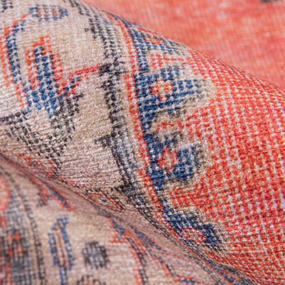 A folded corner of Momeni Afshar Indoor Rug - AFS12 Red displays its soft texture and fine woven details in warm red and blue tones