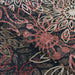 A folded section of Couristan Dolce Indoor/Outdoor Rug - Amalfi/Multi highlights its thick texture and rich red floral designs