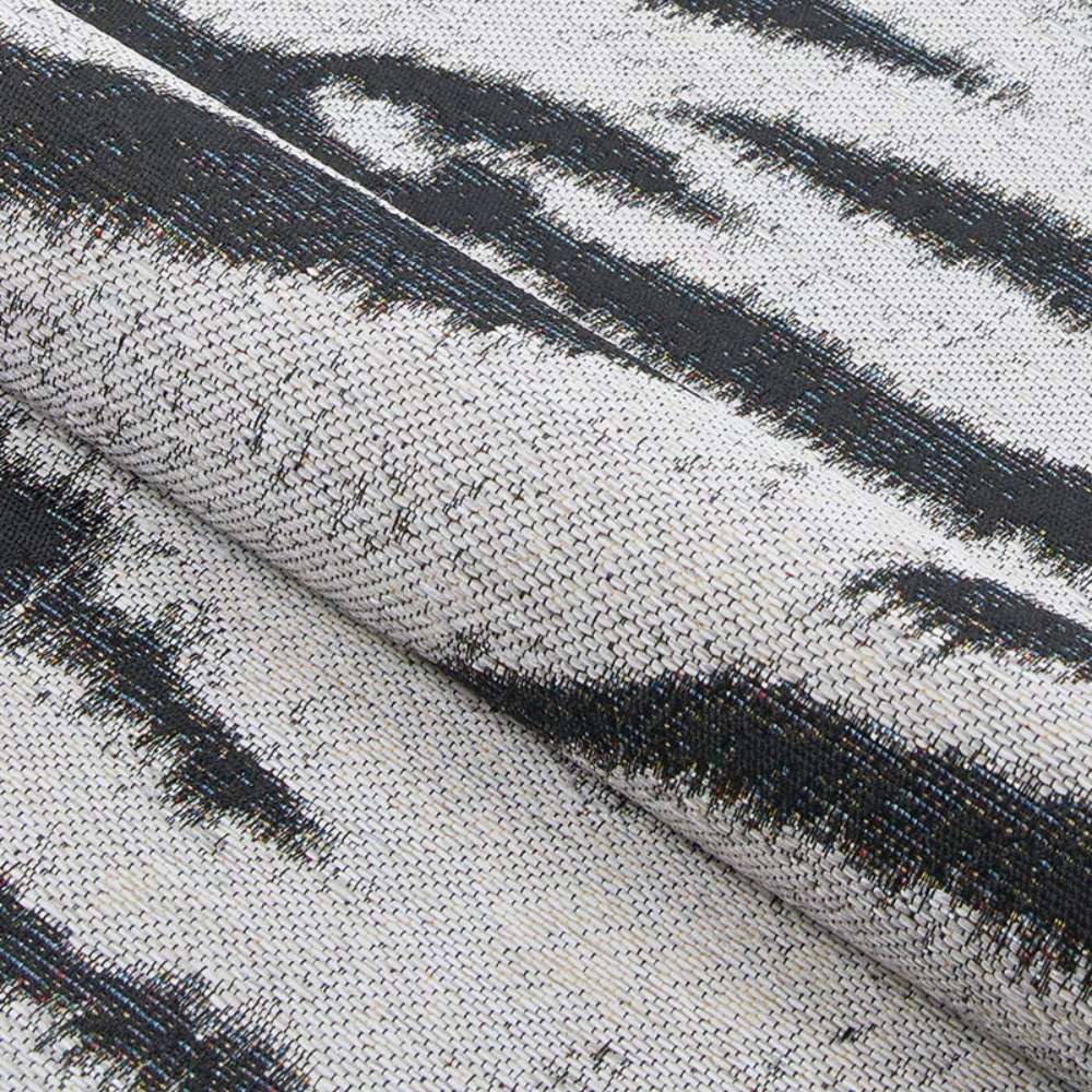 A folded section of Couristan Dolce Indoor/Outdoor Rug - Bengal/Ivory displaying its flexible texture and woven detail