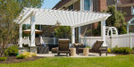 A garden seating area is shaded by a white Structureworks Williamsburg Fiberglass Pergola with fans and elegant columns over a stone base