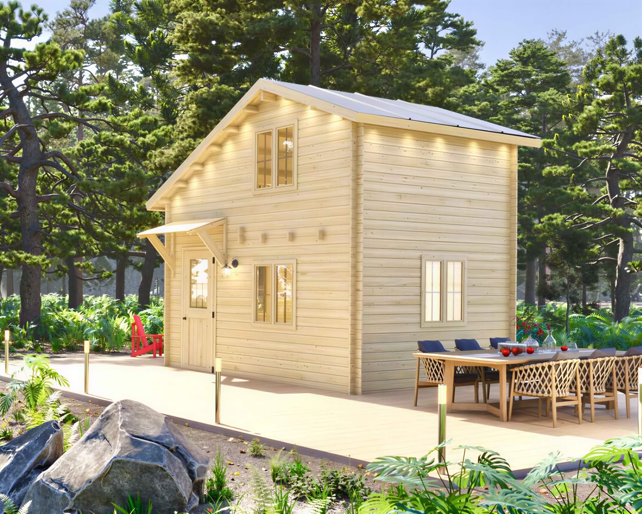 A light wood two-story cabin with warm exterior lighting stands among pine trees, showing the natural charm of the Sawmill Structures BlueWater Loft 160 70mm Garden Room