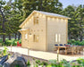 A light wood two-story cabin with warm exterior lighting stands among pine trees, showing the natural charm of the Sawmill Structures BlueWater Loft 160 70mm Garden Room