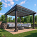 A modern backyard setup features a Structureworks Solare Fiberglass Pergola with patterned shade panels above an outdoor sectional and round table on a wood deck
