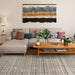 A modern living room features a gray sectional sofa, plants, and Couristan Fez Indoor/Outdoor Rug - Souk/Earthen under a wooden coffee table