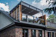 A modern rooftop lounge features a sleek Structureworks Silhouette Aluminum Patio Cover & Pergola with glass railings and shaded seating