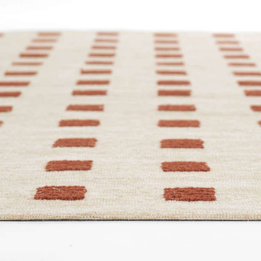 A perspective view highlighting the repeating rows of rust squares across Momeni Archer Indoor Rug - ARC-1 Rust.