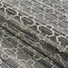 A rolled section of Couristan Fez Indoor/Outdoor Rug - Riad/Tobacco reveals its durable woven texture and intricate design