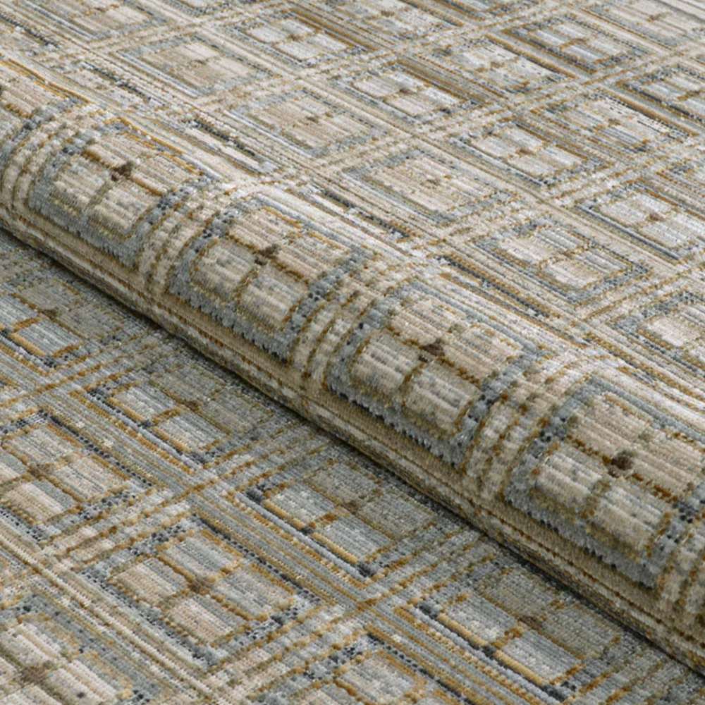 A rolled section of Couristan Fez Indoor/Outdoor Rug - Sidi/Sunlight displays its durable weave and raised pattern texture