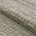 A rolled section of Couristan Fez Indoor/Outdoor Rug - Sidi/Sunlight displays its durable weave and raised pattern texture