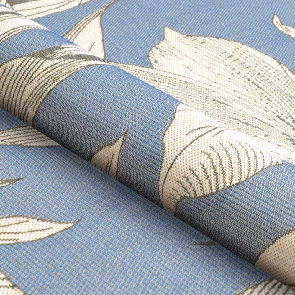 A rolled view of Couristan Dolce Indoor/Outdoor Rug - Flora/Ice reveals its flexible material and the detailed botanical patterns in cream tones on blue