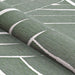 A rolled view of Couristan Dolce Indoor/Outdoor Rug - Parquet/Fern reveals its flexible texture and leaf-like line patterns