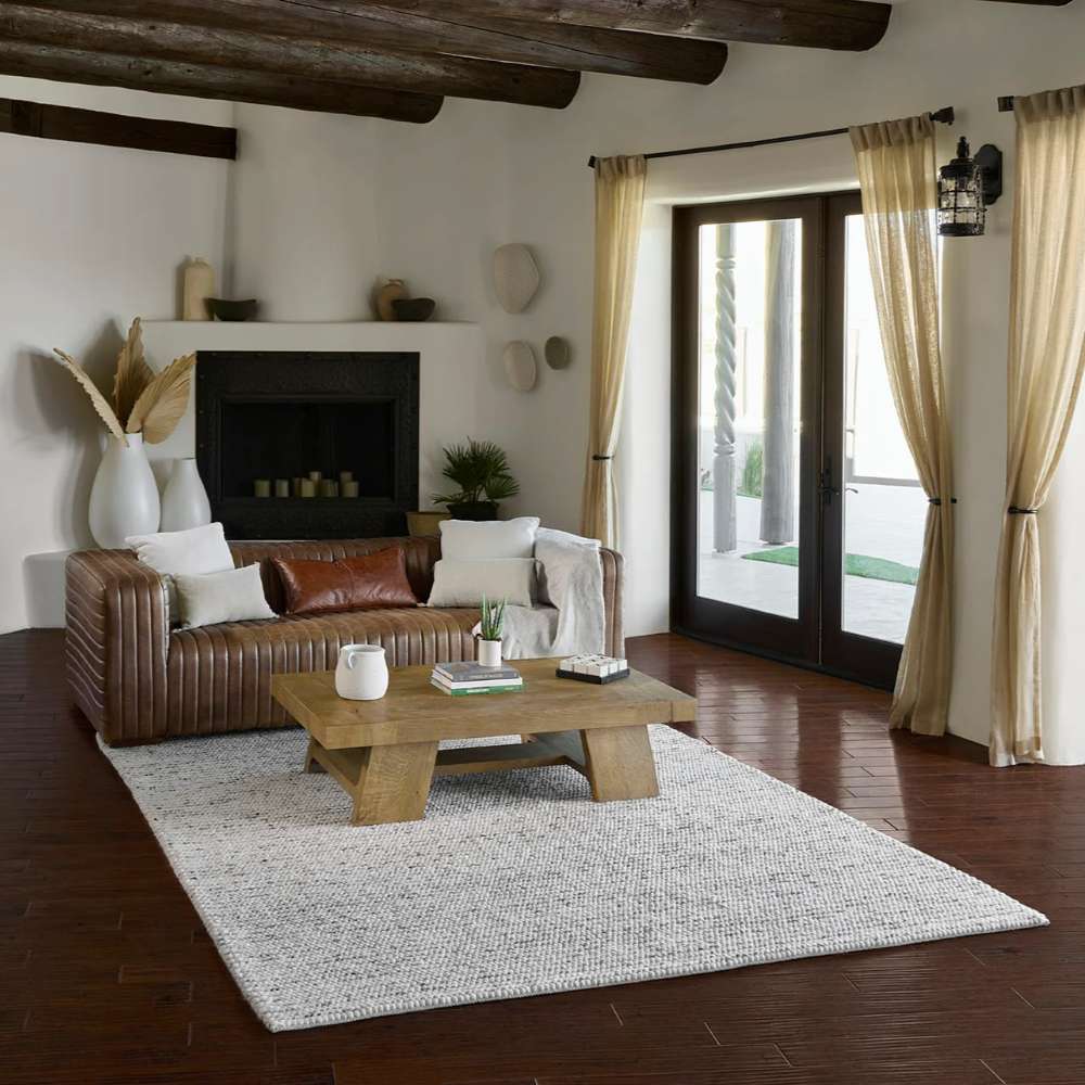A rustic living space with the Momeni Andes Indoor Rug - AND-8 Ivory